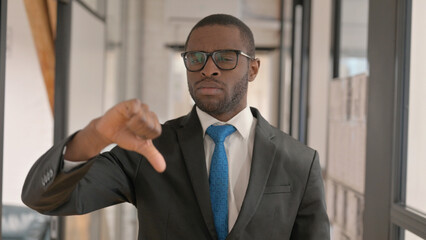 Portrait of African Businessman with Thumbs Down Looking at Camera