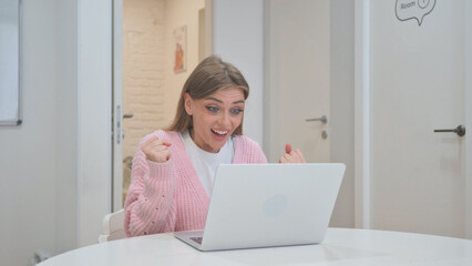 Business Woman Celebrating Success on Laptop