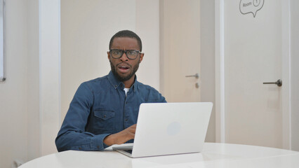 Shocked Young African Man while Looking at Camera
