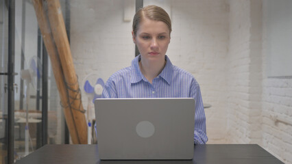Busy Young Woman Typing on Laptop