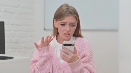 Portrait of Creative Young Woman Shocked by Online Loss on Phone