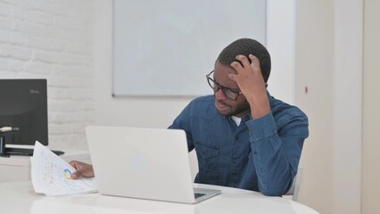 Cursing Middle Aged African Man Reacting to Annual Business Report