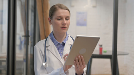 Portrait of Young Female Doctor Using Digital Tablet