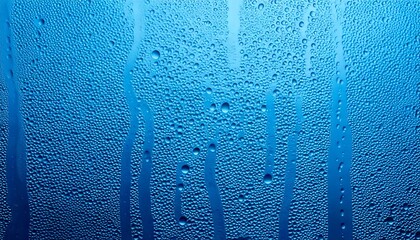Water, rain, and shower drops create a seamless blue background that captures the delicate condensation of fog. This closeup view highlights the natural beauty and texture of moisture in an atmospheri