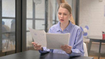 Cursing Young Woman Reacting to Business Report, Paperwork