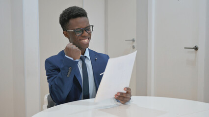 Excited African Businessman Reacting to Good News