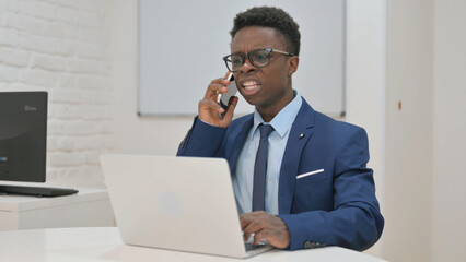 Young African Businessman Reacting Negatively on a Phone Call