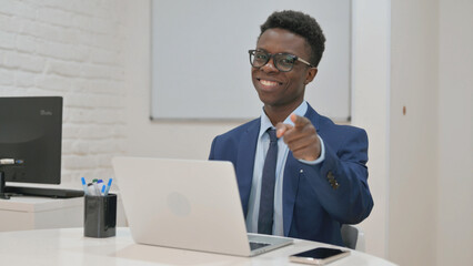Enthusiastic Young Businessman Pointing at Camera