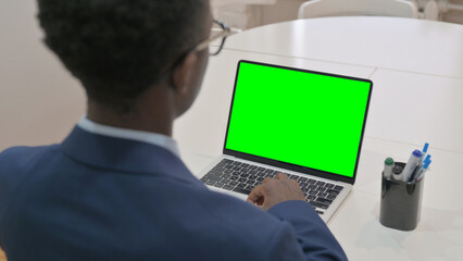 Overhead View of Young Businessman Using Laptop with Green Screen