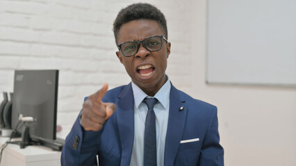 Angry Young Businessman Pointing and Yelling