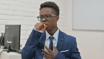 Sick Young Businessman Coughing at Work