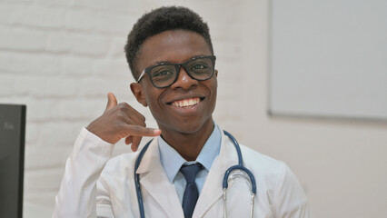 African American Doctor Making a Call Me Gesture