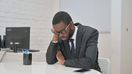Tired African American Businessman at Desk