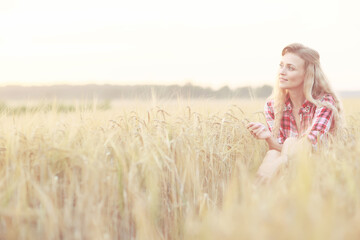 romantic girl posing in a summer field dress