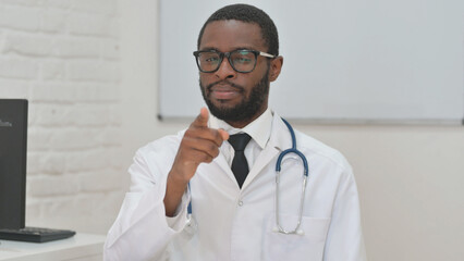 Portrait of Confident Black Doctor Pointing Directly