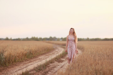 girl walks along an agricultural field road