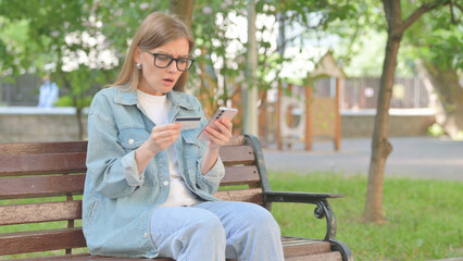 Tense Young Woman Looking Concerned While Making an Online Transaction