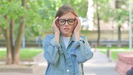 Troubled Young Woman with Headache Outdoors