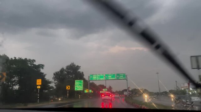 Rainy Evening Drive Captured Through Car Front Window
