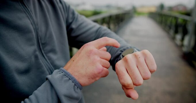 Check time, outdoor and man with fitness, hands and exercise with wellness, app and training. Closeup, person and athlete with smart watch, bridge and track progress with challenge, stats and monitor