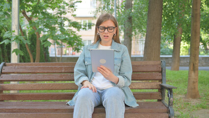 Casual Woman Expressing Disbelief While Using a Tablet