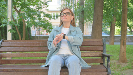 Waiting Casual Woman Checking Wrist Watch on Park Bench