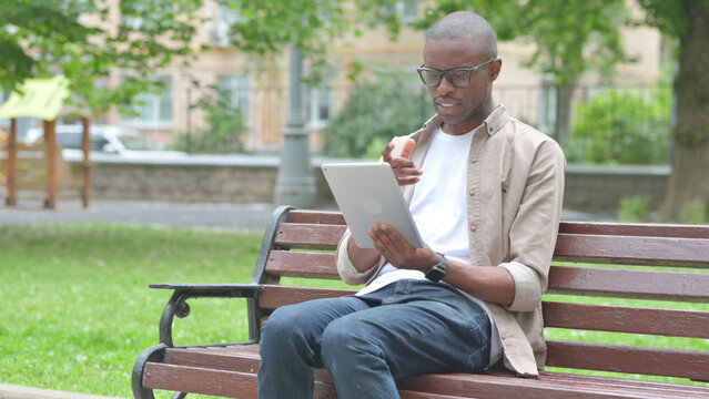 Young African Man Video Calling or Conferencing on a Tablet