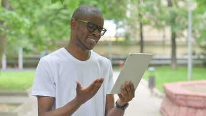 Young African Man Reacting with Shock or Disbelief to Tablet Content