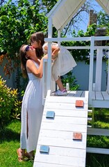 Mother and daughter in white are on the play ground