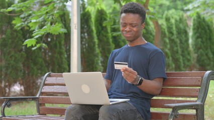 Casual African Man Reacting to Online Shopping Failure with Credit Card