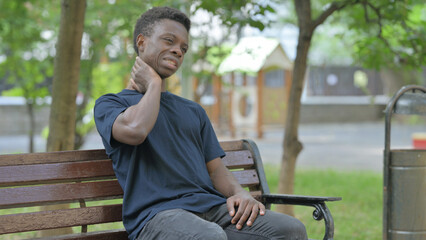 African American Man with Neck Pain Sitting Outdoor