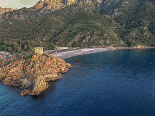 Aerial view town ruins Genoese tower of Porto Corsica France medieval watchtower Mediterranean Sea...