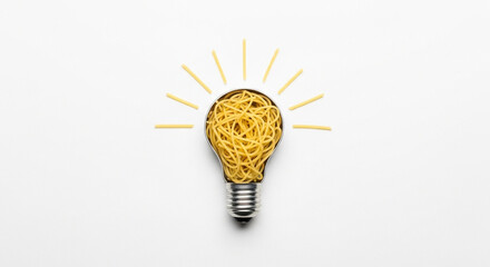 Lightbulb filled with spaghetti and spaghetti radiating out on a white background studio shot