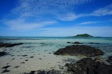 clear rock beach and charming clouds