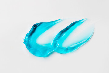 Smears of blue cosmetic gel on a white background