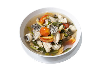 A Delicious bowl of Fish soup: The appetizing fish soup in a white bowl featuring the fresh cut of...