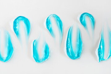 Smears of blue cosmetic gel on a white background