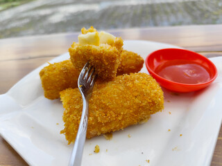 Crispy golden rissoles with savory and delicious filling, served on an elegant white plate,...