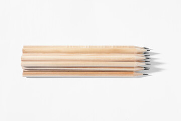 Many sharp graphite pencils on white background
