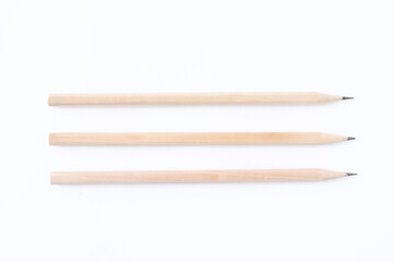 Three graphite pencils on white background, flat lay