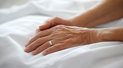 Elderly woman's hands resting on bed, hospital background, healthcare brochure