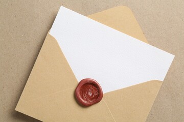 Blank invitation card and envelope on carton, top view. Space for design