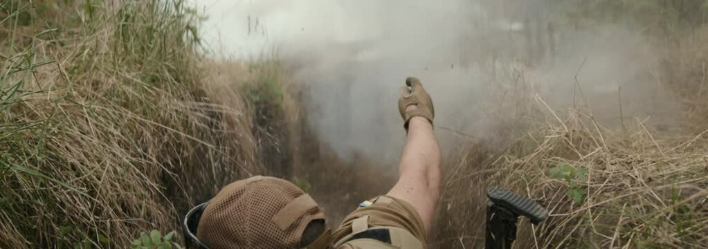 Press interviews soldier in a combat zone, shelling suddenly begins, soldiers quickly escort journalists out of the trench. Concept frontline journalism, evacuation, risk, army support.