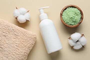 Flat lay composition with bottle of liquid soap and cotton flowers on beige background