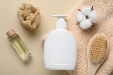 Flat lay composition with bottle of liquid soap and cotton flower on beige background
