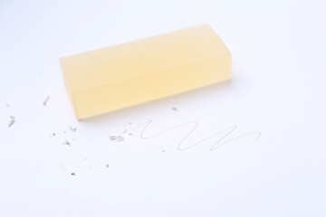 Eraser, doodle and scraps on white background, selective focus