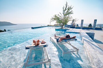 Relaxing Poolside on Lounge Chairs with Stunning Ocean Views