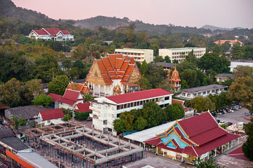 Fototapeta premium Aerial View of Architectural Temple Complex with Vibrant Roofs in Tranquil Setting