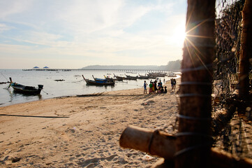 Serene Beach Scene With Fishing Boats and Rustic Traps at Sunrise