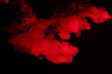 Hookah smoke in red light on black background, closeup